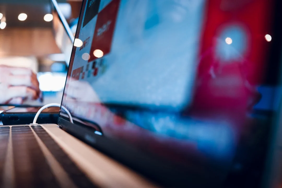 our-story Close-up of a smartphone with a stylus on a bright red surface, showcasing modern technology.